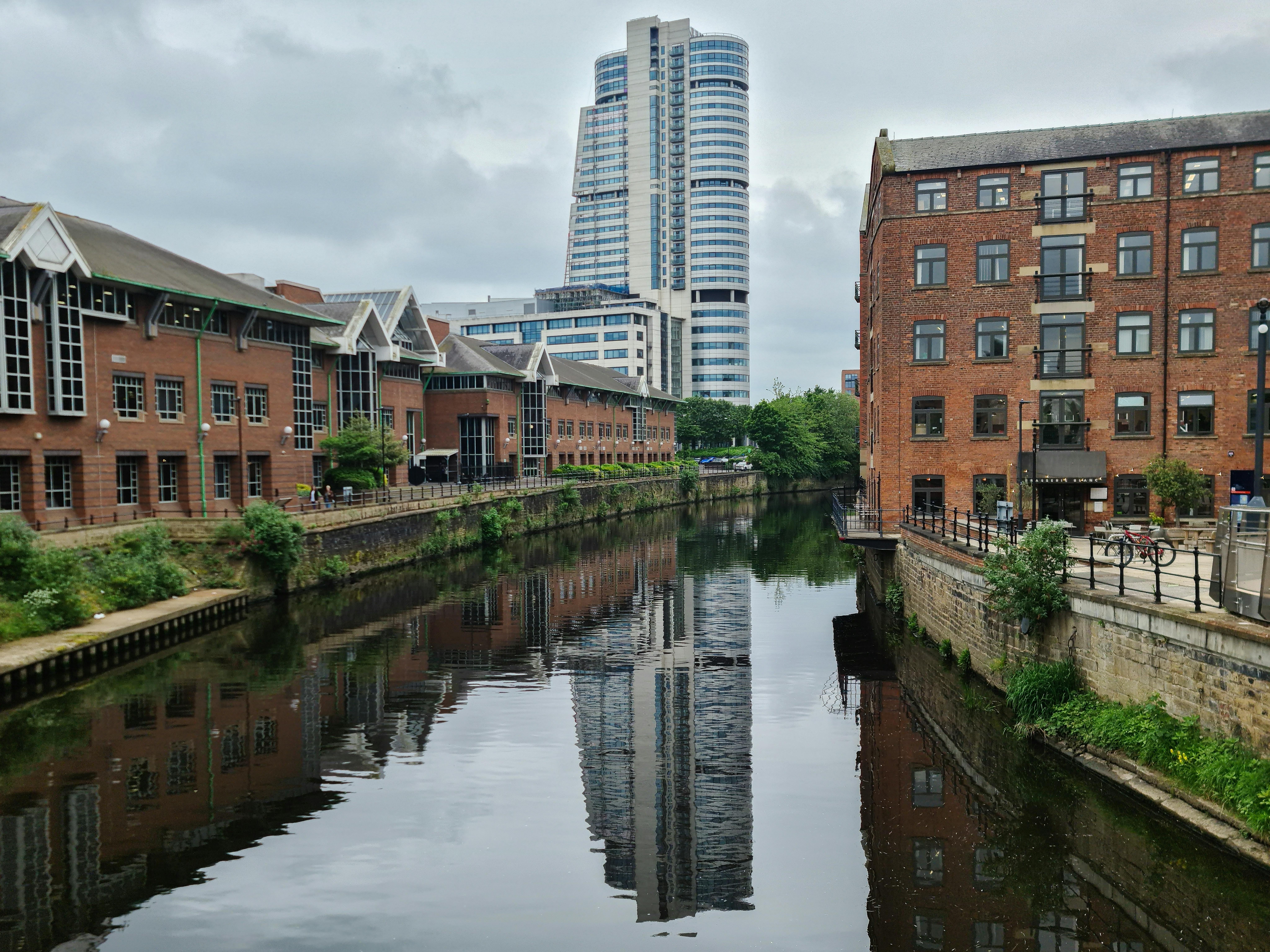 Scenic view of Leeds skyline showcasing a blend of historic and modern architecture along the canal.