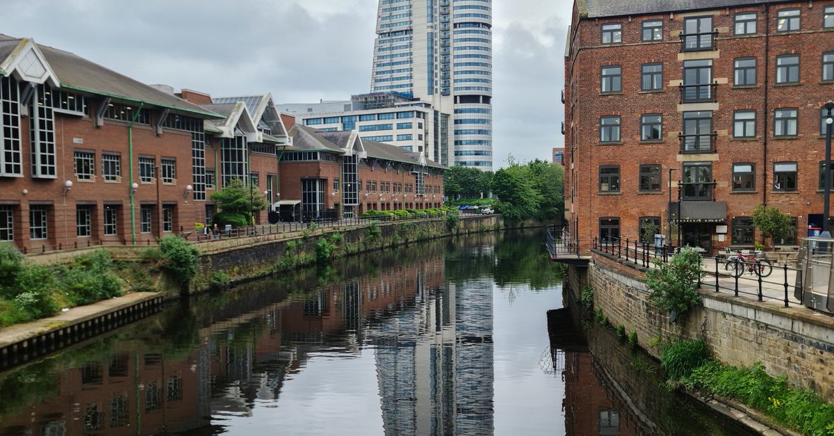 Scenic view of Leeds skyline showcasing a blend of historic and modern architecture along the canal.