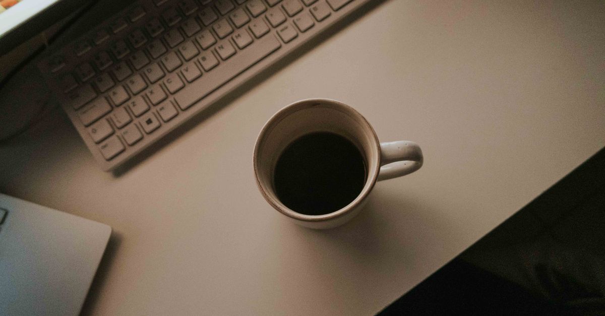minimalist workspace with closed laptop and tea, calm aesthetic