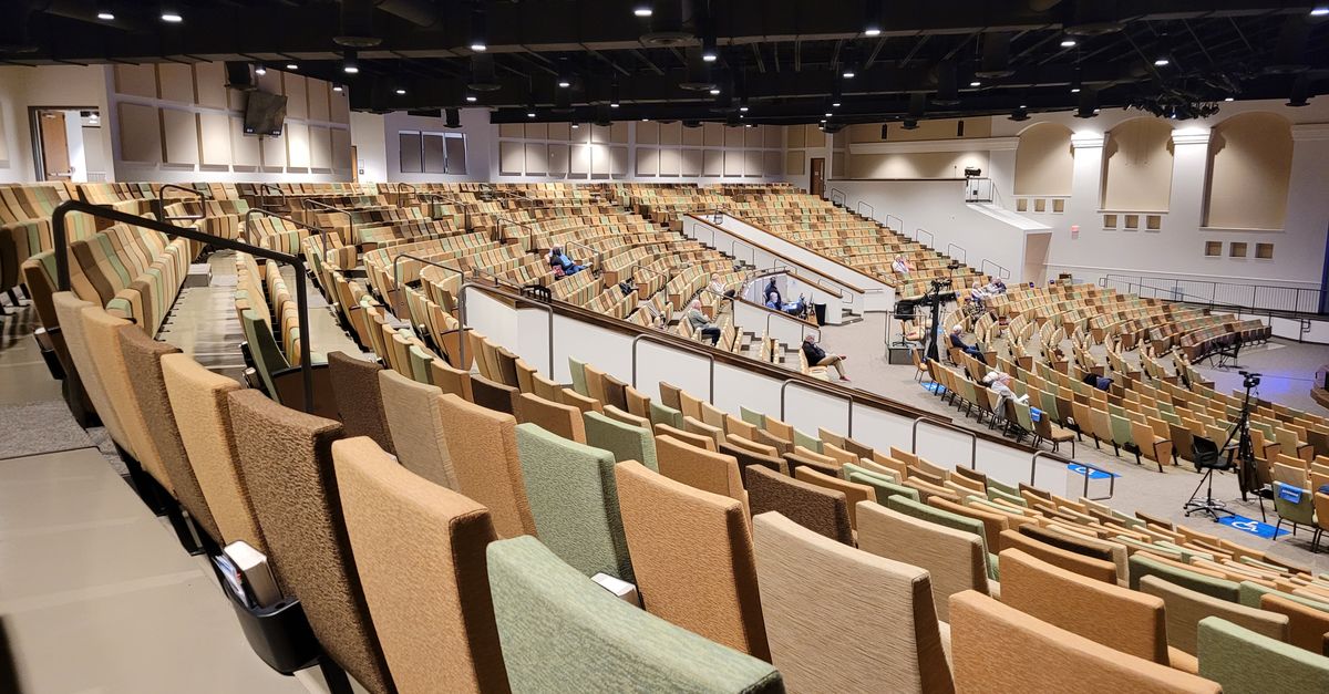 modern church building interior with large stage and lighting in Ho Volta Region