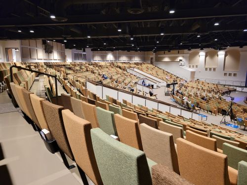 Free Large auditorium with tiered seating and stage setup, perfect for events or worship. Stock Photo