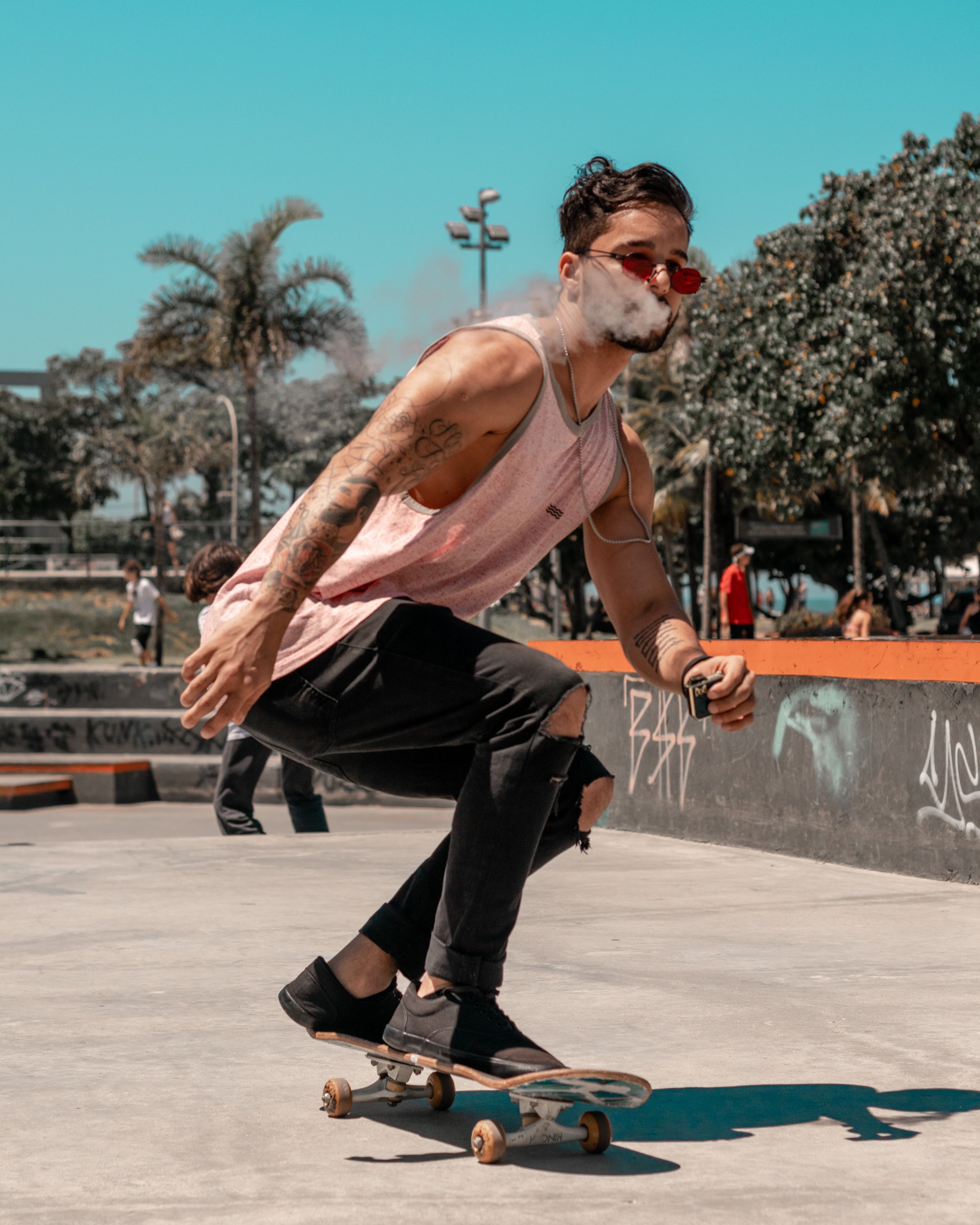 Photo of Man in Pink Tank Top and Black Jeans Smoking a ... - 1200 x 627 jpeg 87kB