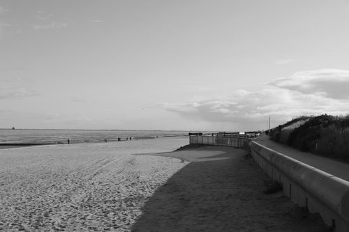 Free Dramatic black and white photo of a seaside beach at day. Stock Photo