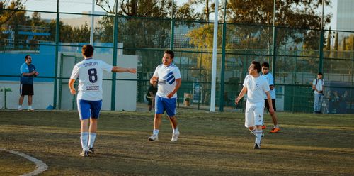 Free A lively amateur soccer match with players celebrating on a sunny day outdoors. Stock Photo