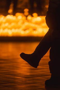 Silhouette against a warm glow of candlelight creating a peaceful and tranquil atmosphere.