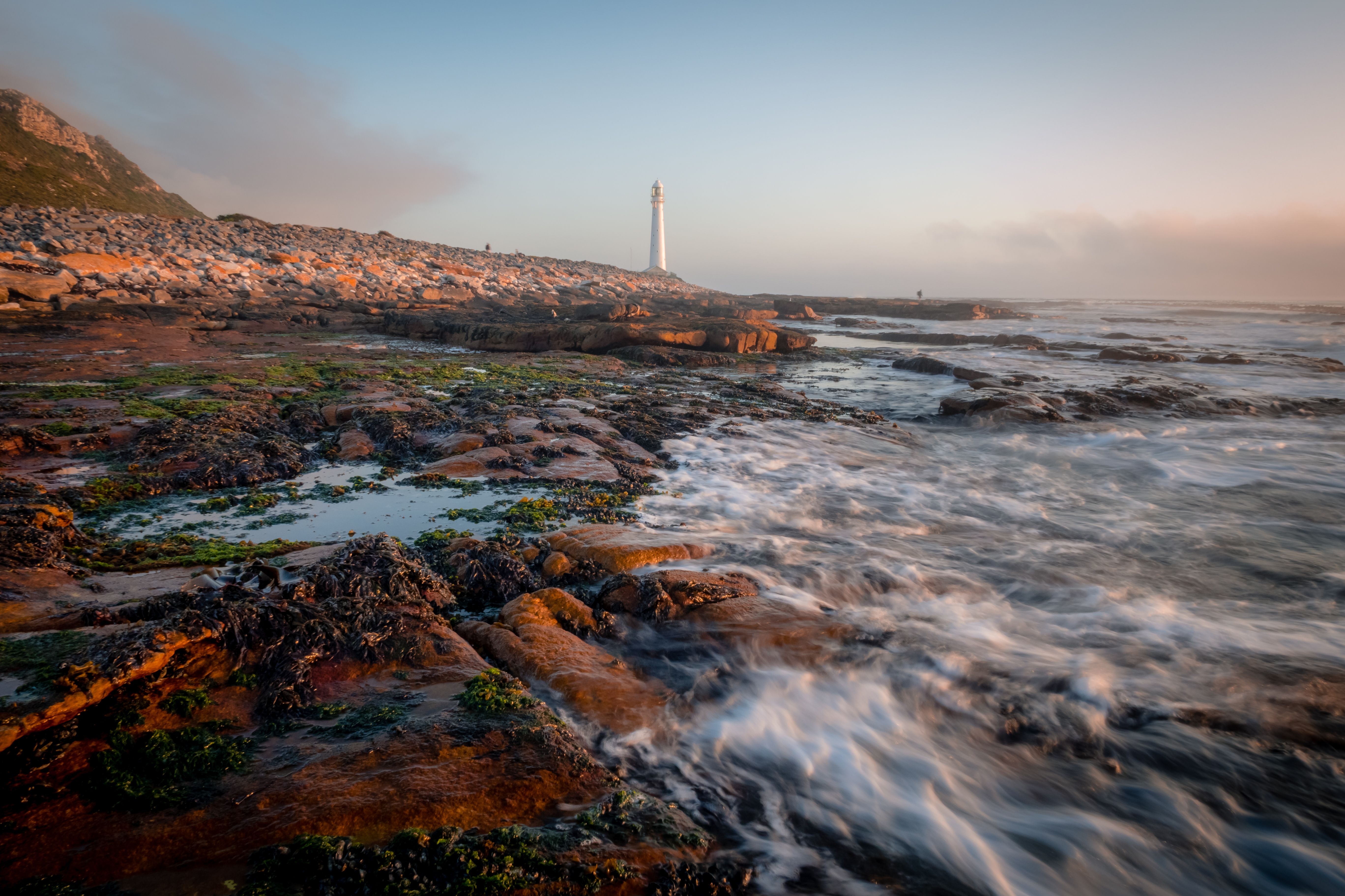 Rocky Atlantic coastline with lighthouse in distance