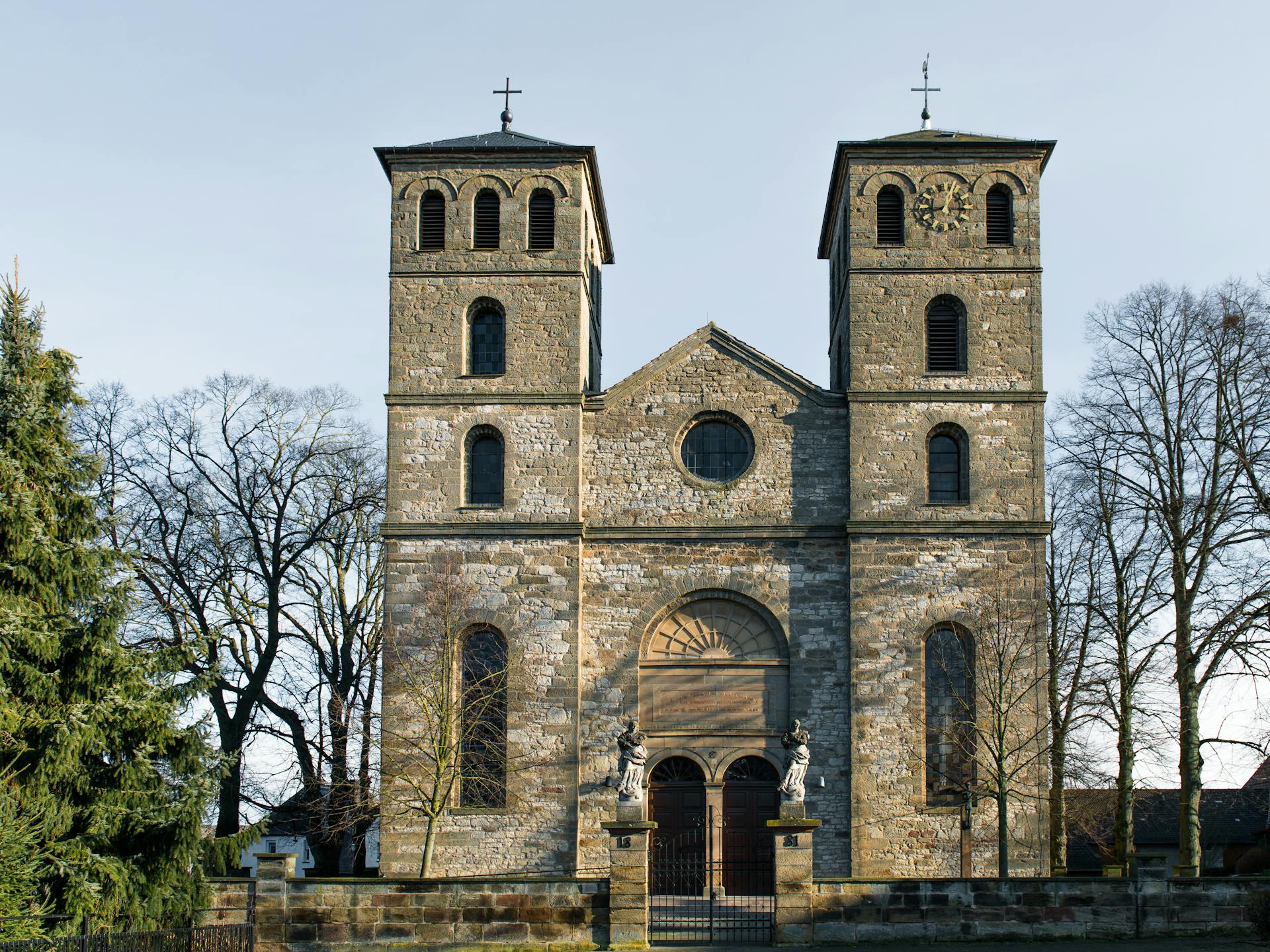 Front view of a historic church in Warburg, Germany showcasing Romanesque architecture.