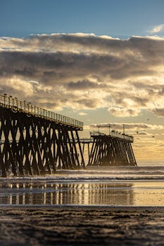 Stunning sunset view of Rosarito Beach, capturing the pier under vibrant skies.