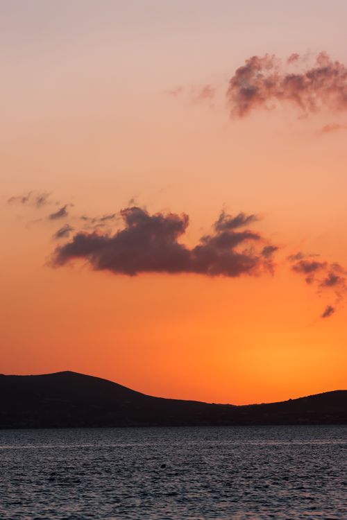 Free Experience the vibrant hues of a Naxos sunset over the Aegean Sea, capturing the serene beauty of Greece. Stock Photo