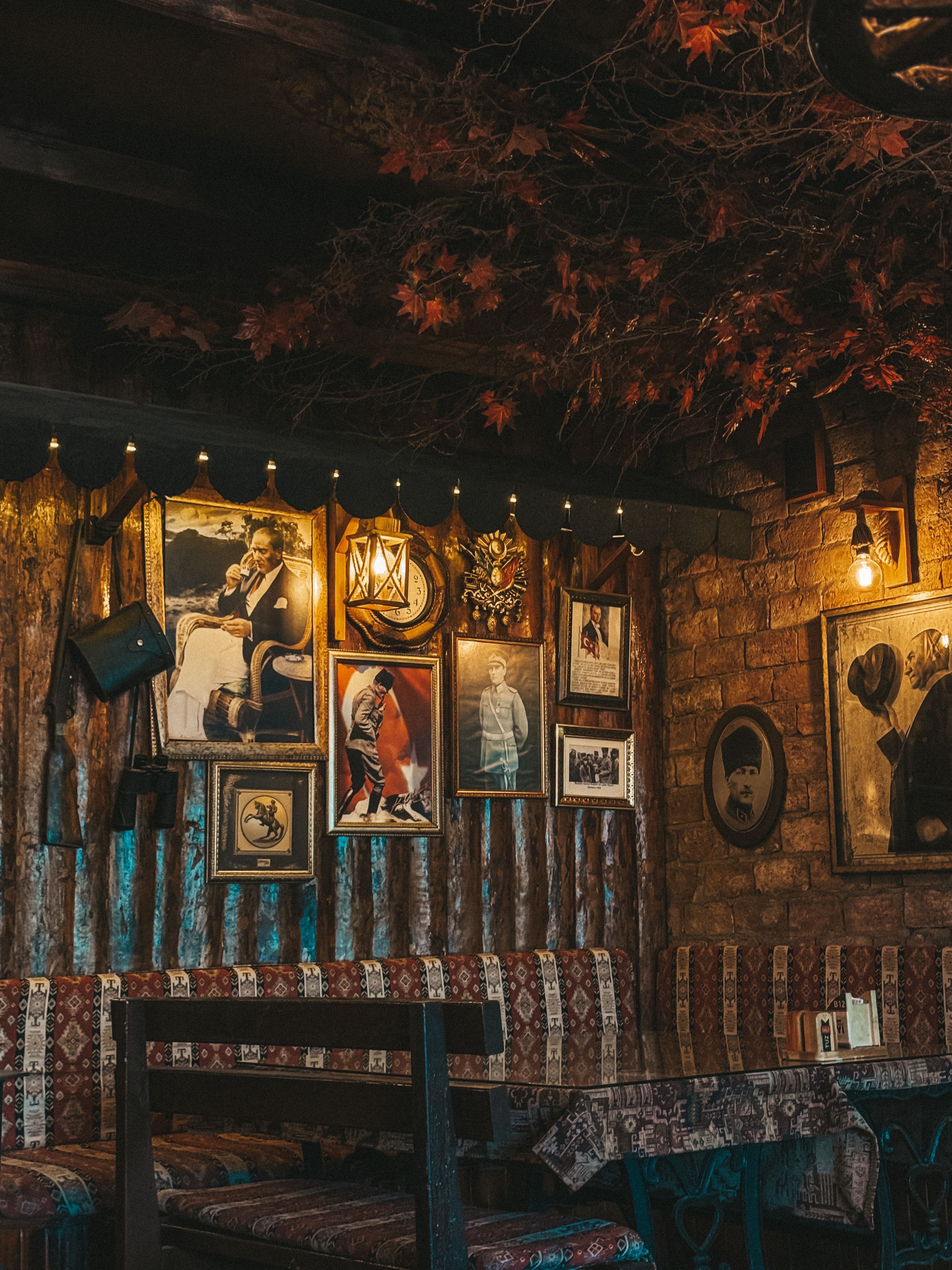 The back wall, hung with prints and old photographs
