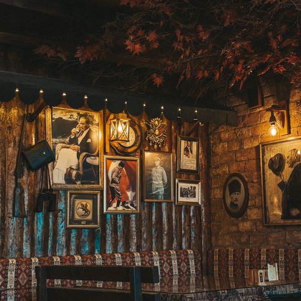 The back wall, hung with prints and old photographs