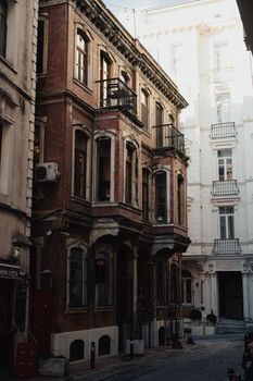 Organic tones highlight a charming historic street in Beyoğlu, Istanbul, showcasing aged brick facades.