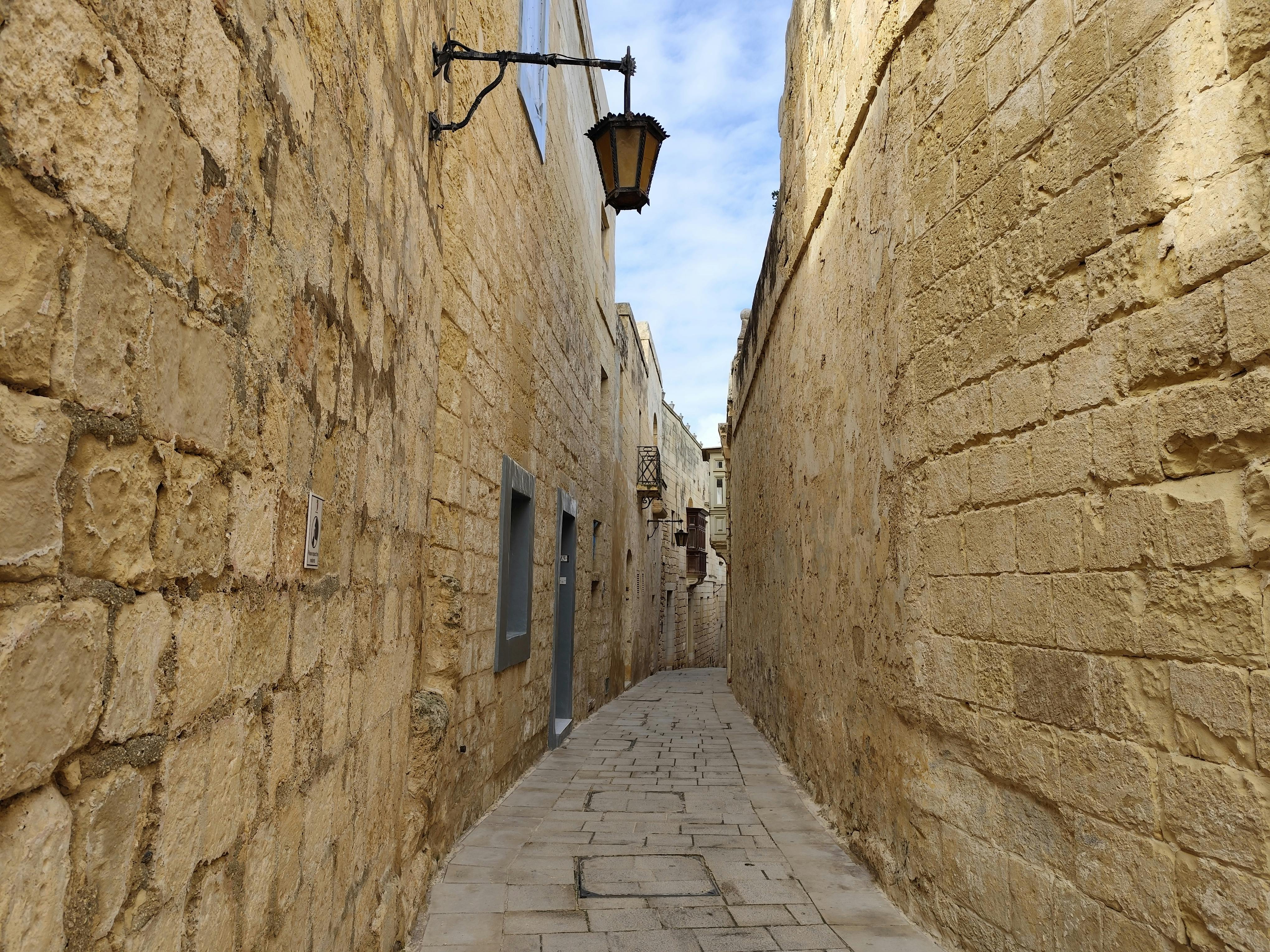 Explore the charming stone alleyways of Mdina, Malta's ancient city, lined with historic architecture.