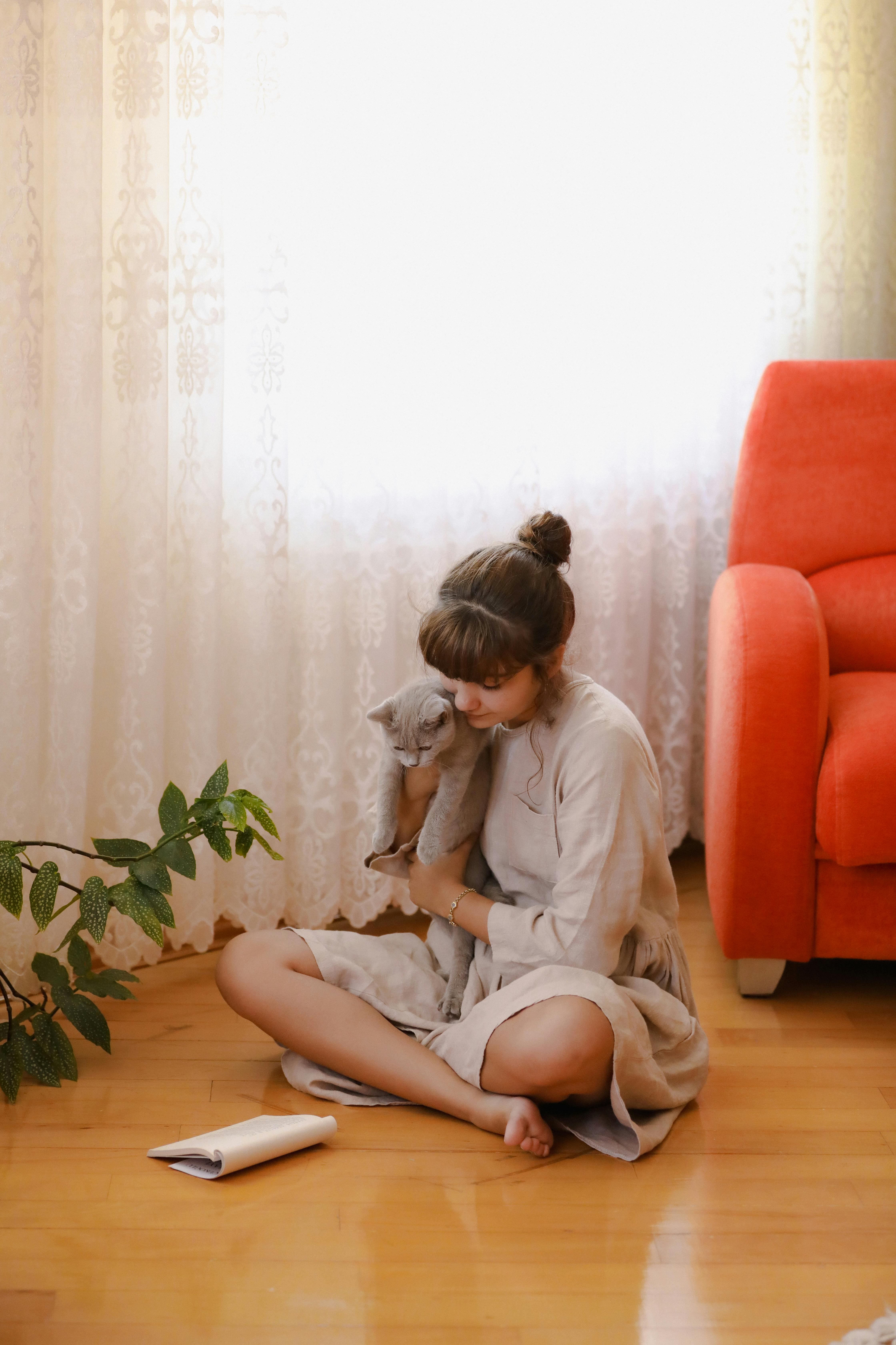 Woman enjoying a cozy morning at home with her British Shorthair cat in Istanbul.