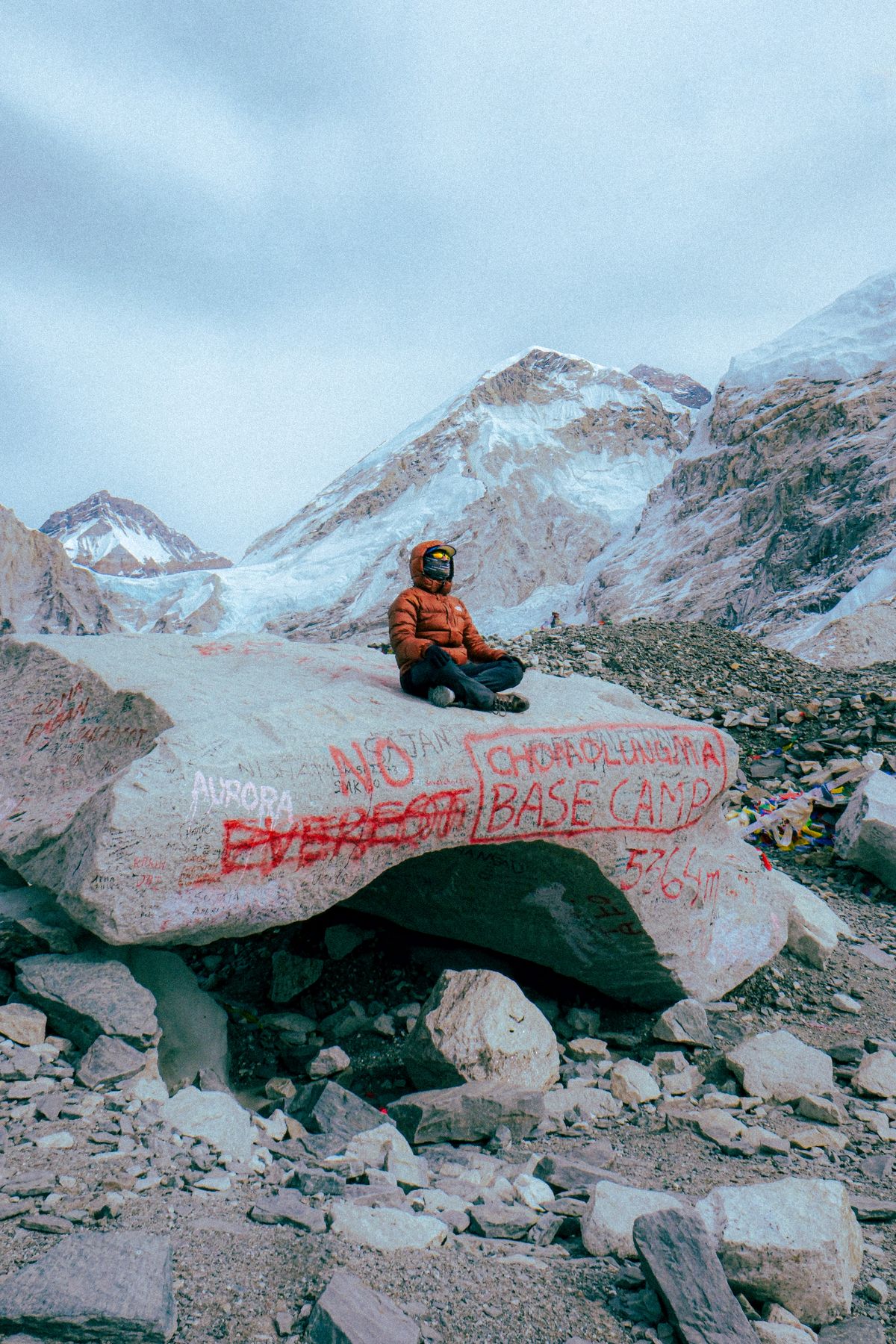 Trekker at Everest Base Camp Nepal surrounded by dramatic Himalayan mountain panorama