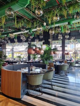 Stylish restaurant interior with lush greenery and artistic lighting in Ankara.