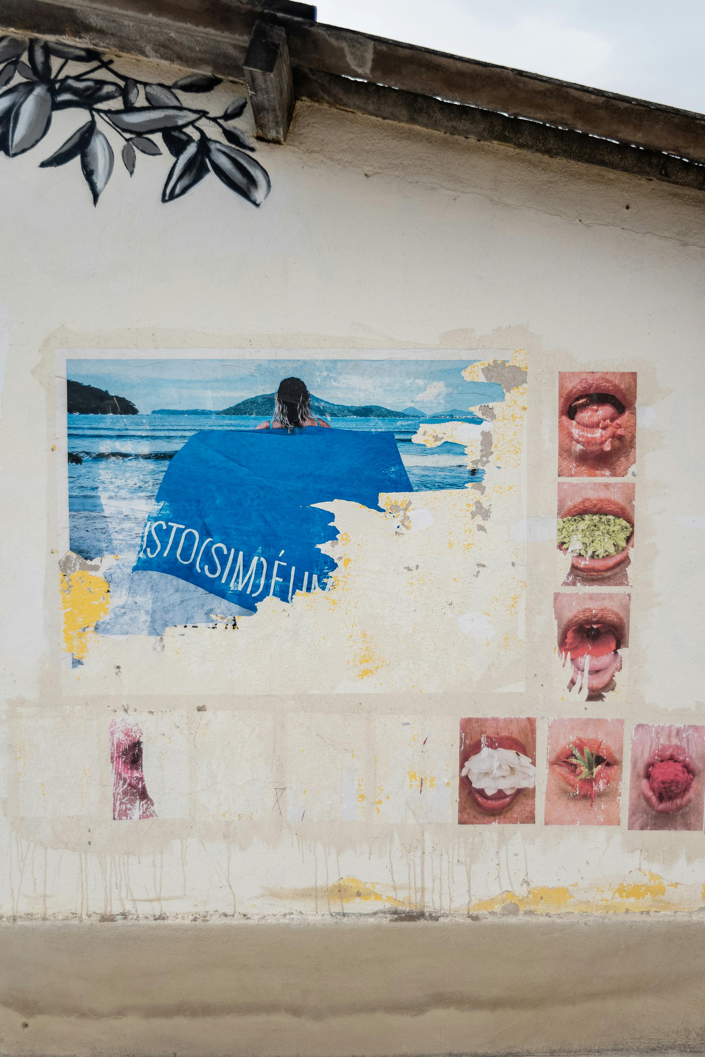 A captivating display of street art featuring colorful posters on an old wall.