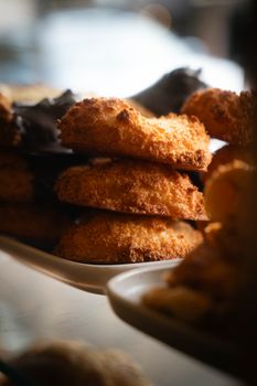 A close-up of a stack of golden, crunchy biscuits on a plate, indoors.