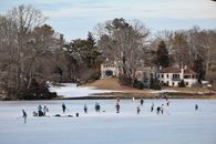 People playing ice hockey on Gorham's Pond in winter, Darien, Connecticut.