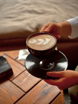 A close-up shot of a latte with beautiful art in a cozy cafe, capturing warm tones.