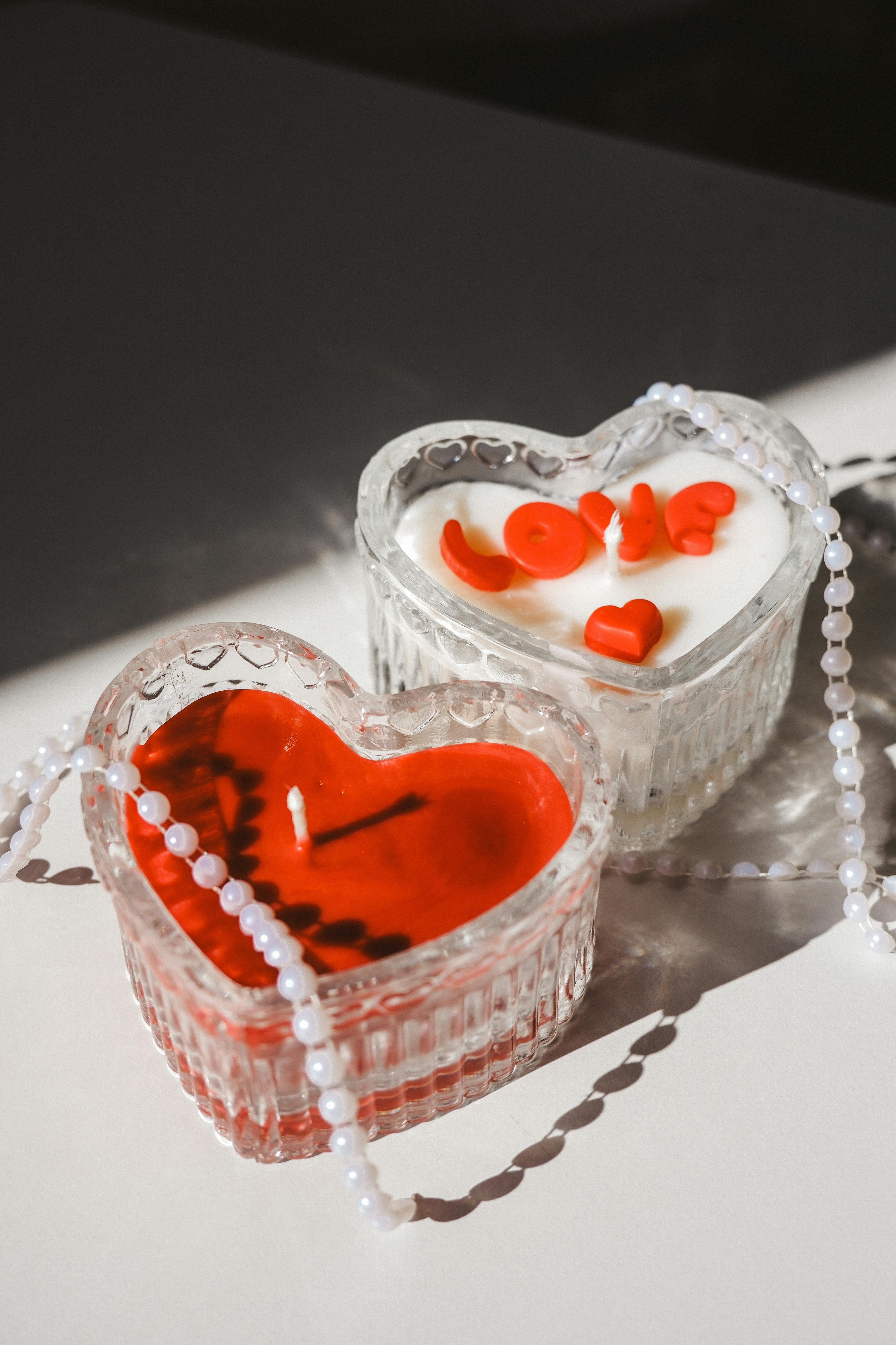 Heart-shaped candles with pearls create a romantic and elegant setting.