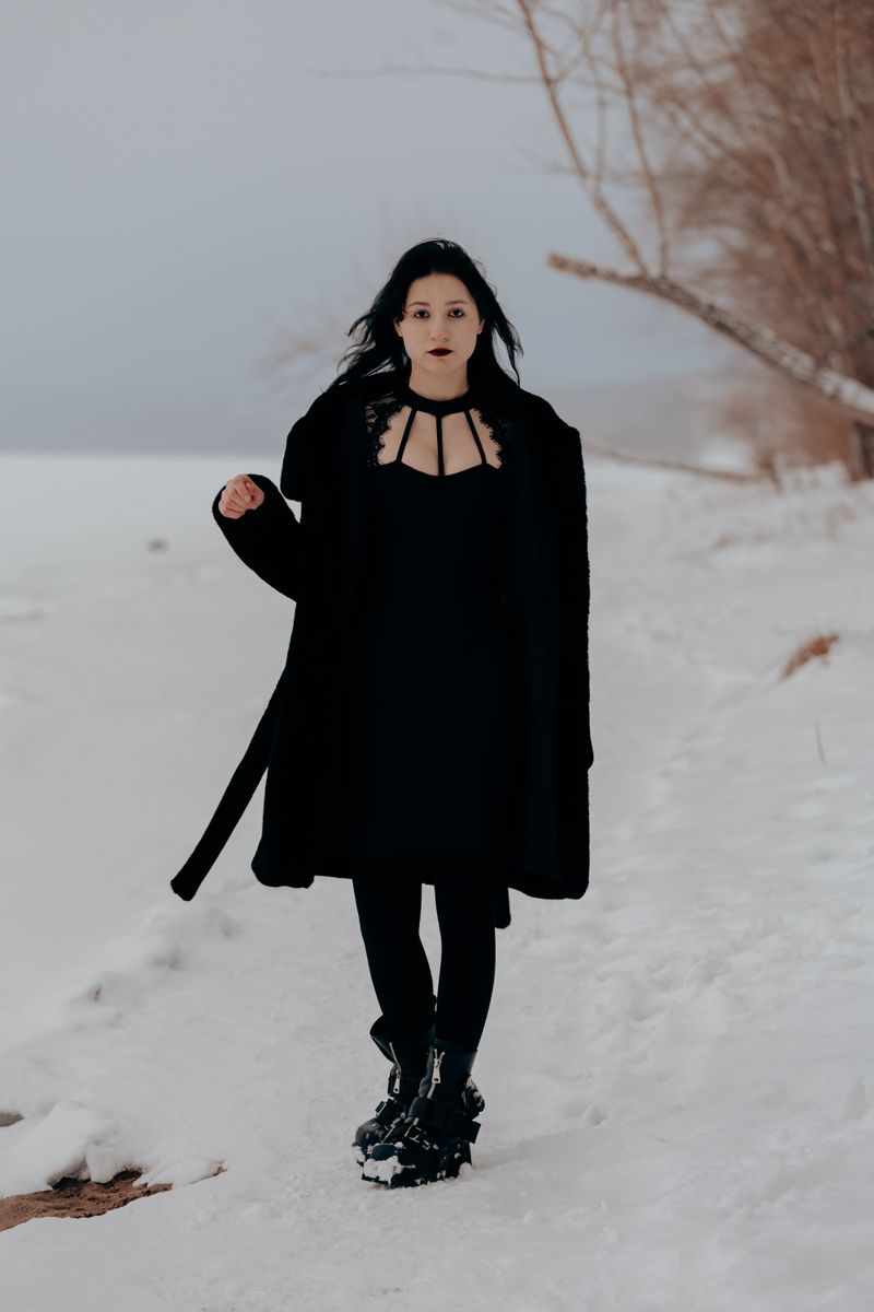woman in all-black monochrome knit outfit