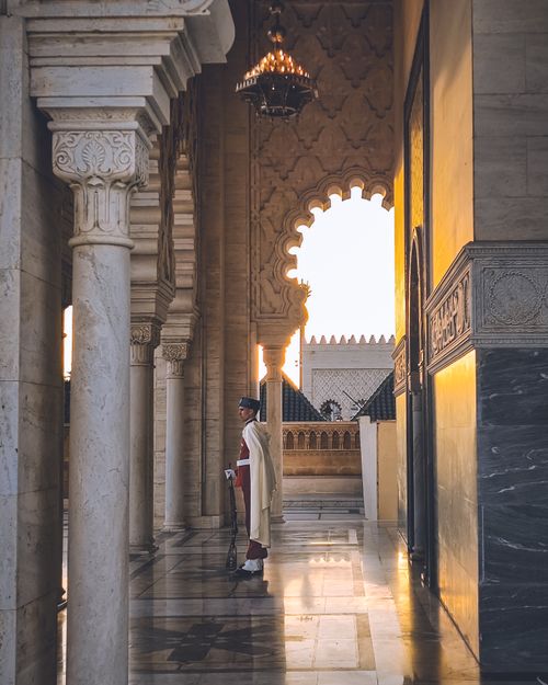 Free Elegant Moroccan architecture with a royal guard during sunset at Mohammed V Mausoleum in Rabat, Morocco. Stock Photo