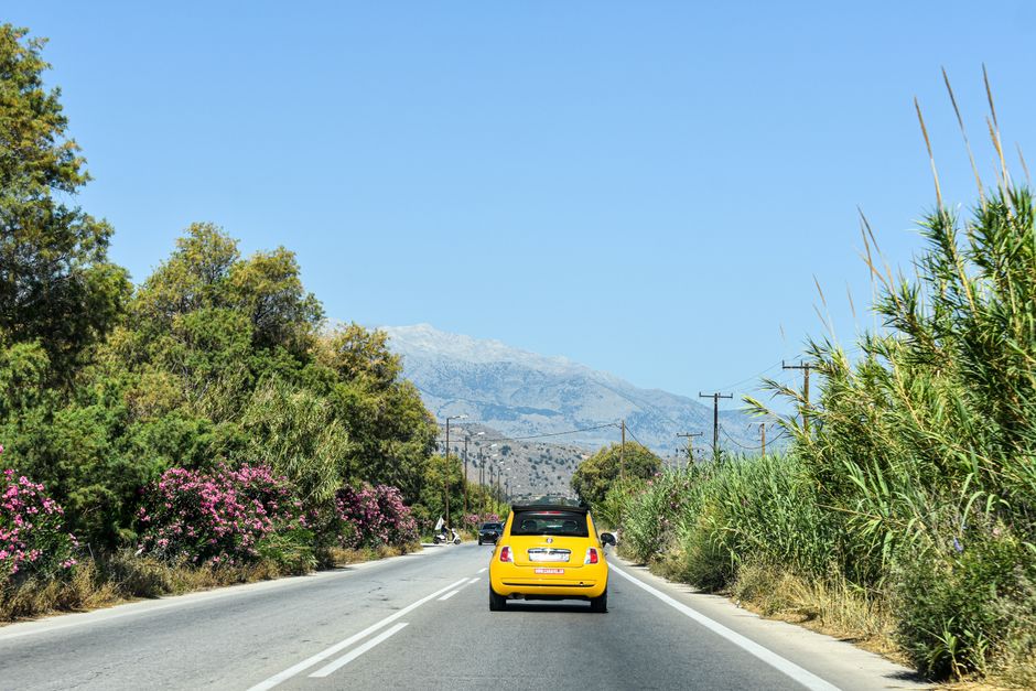 A car approaching a toll booth on a major highway in Greece