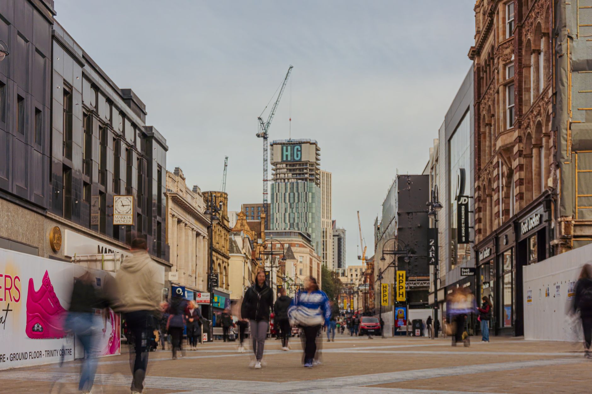 Bustling pedestrian street in downtown Leeds city centre, West Yorkshire, England