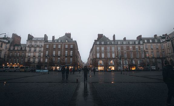 A misty day in a European city square, featuring classic architecture and atmospheric lighting.