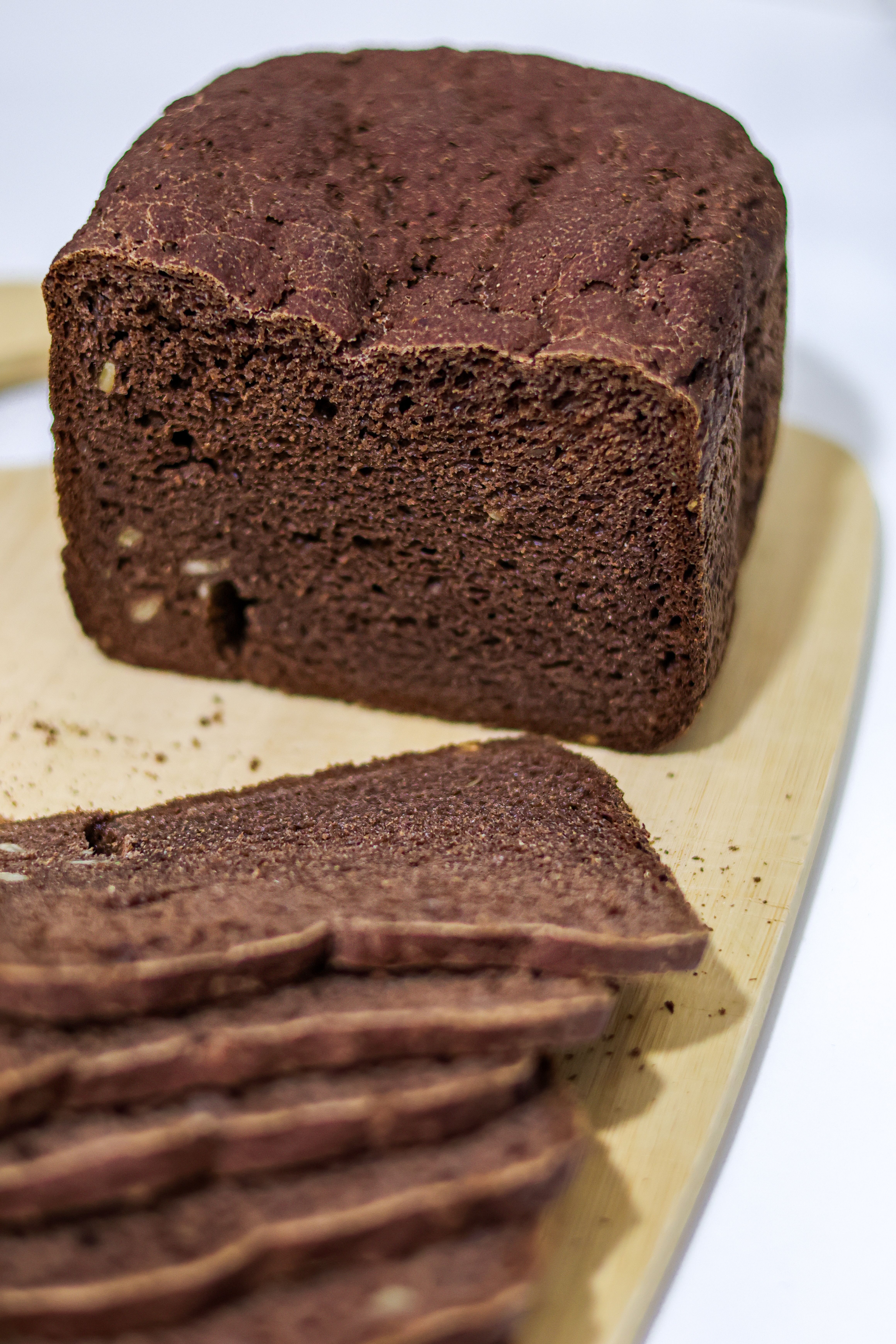 Delicious homemade cocoa brown bread with slices on a board. Perfect for baking and food visuals.
