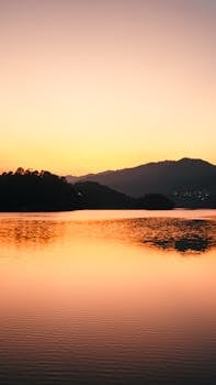Captivating sunset over water and hills in Nuevo Necaxa, Puebla, Mexico.