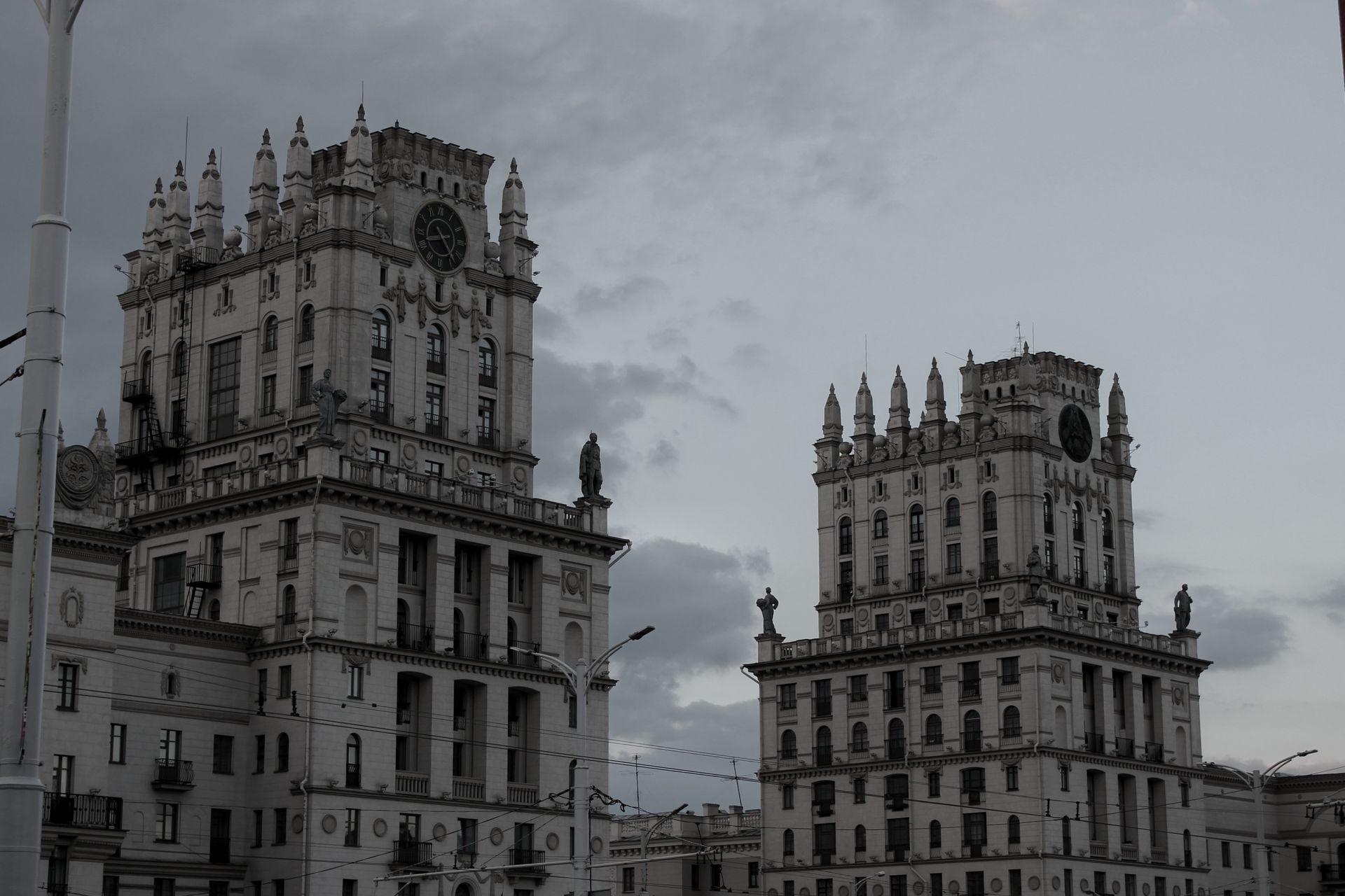 Dramatic view of Soviet-era buildings under cloudy skies in Wrocław, Poland.