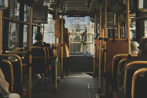 Free Passengers riding a city bus in Wrocław, Poland, showcasing daily public transport life. Stock Photo