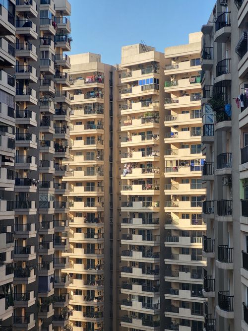 Free Modern high-rise residential buildings captured on a clear sunny day in Greater Noida, India. Stock Photo