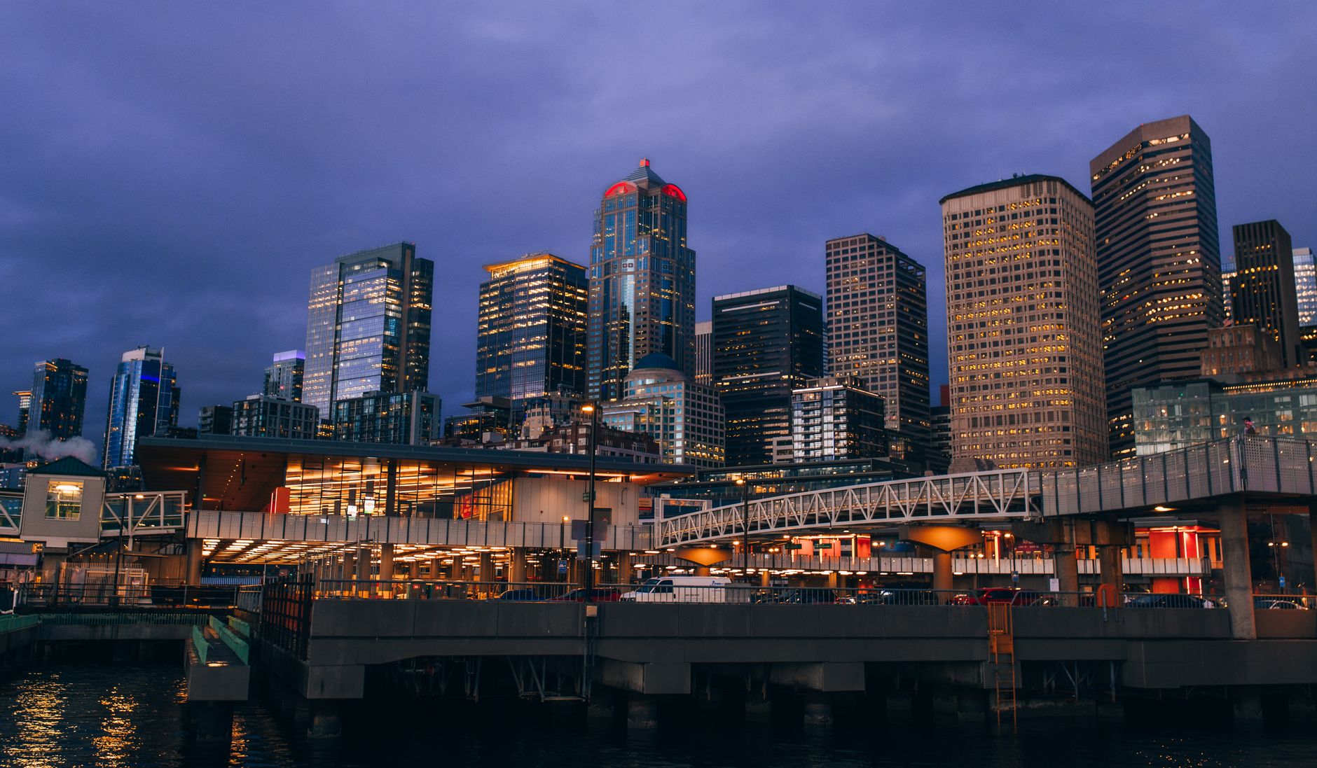 A scenic twilight view of the Seattle skyline seen from the waterfront.