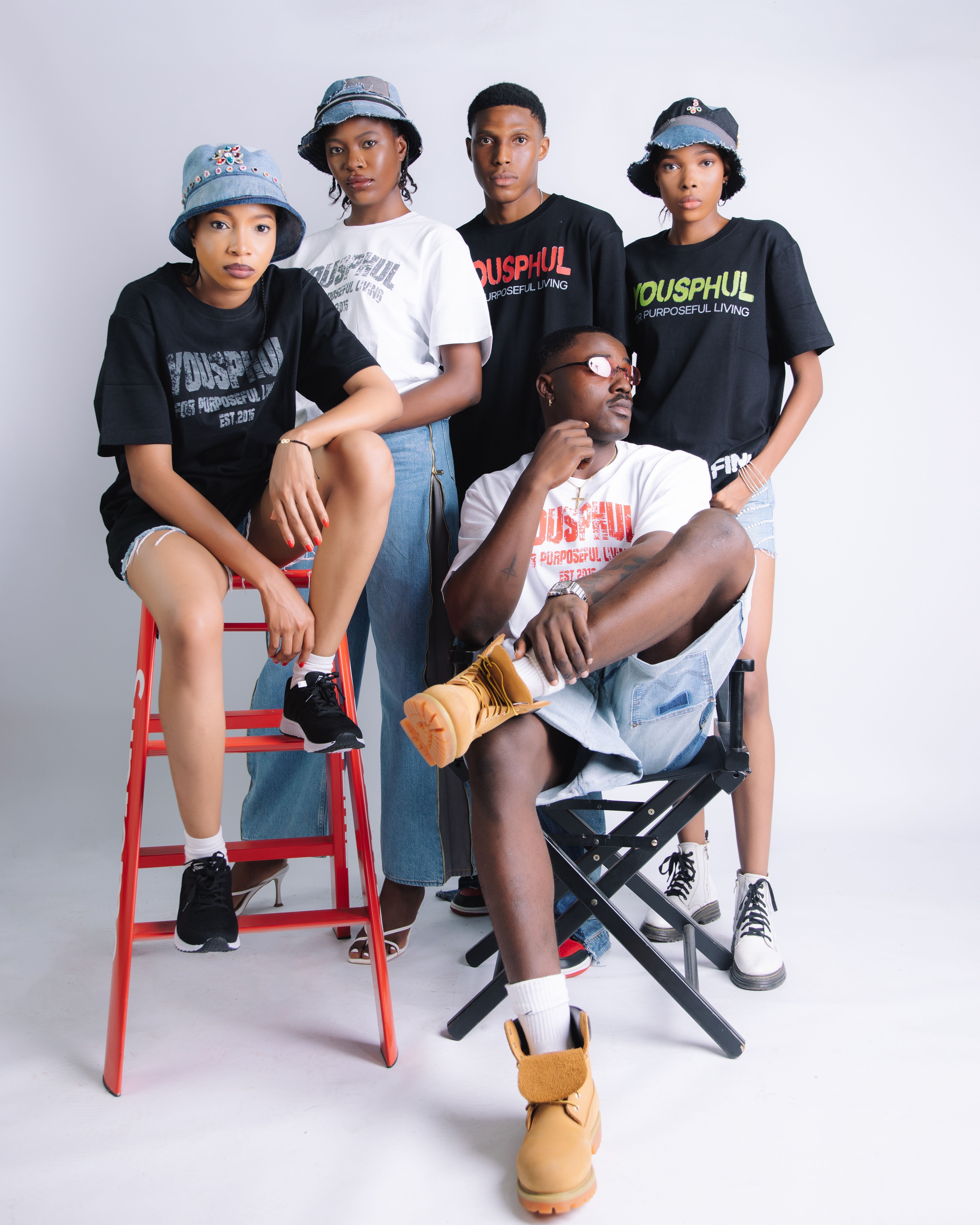 Group of young adults in casual fashion poses against white background.