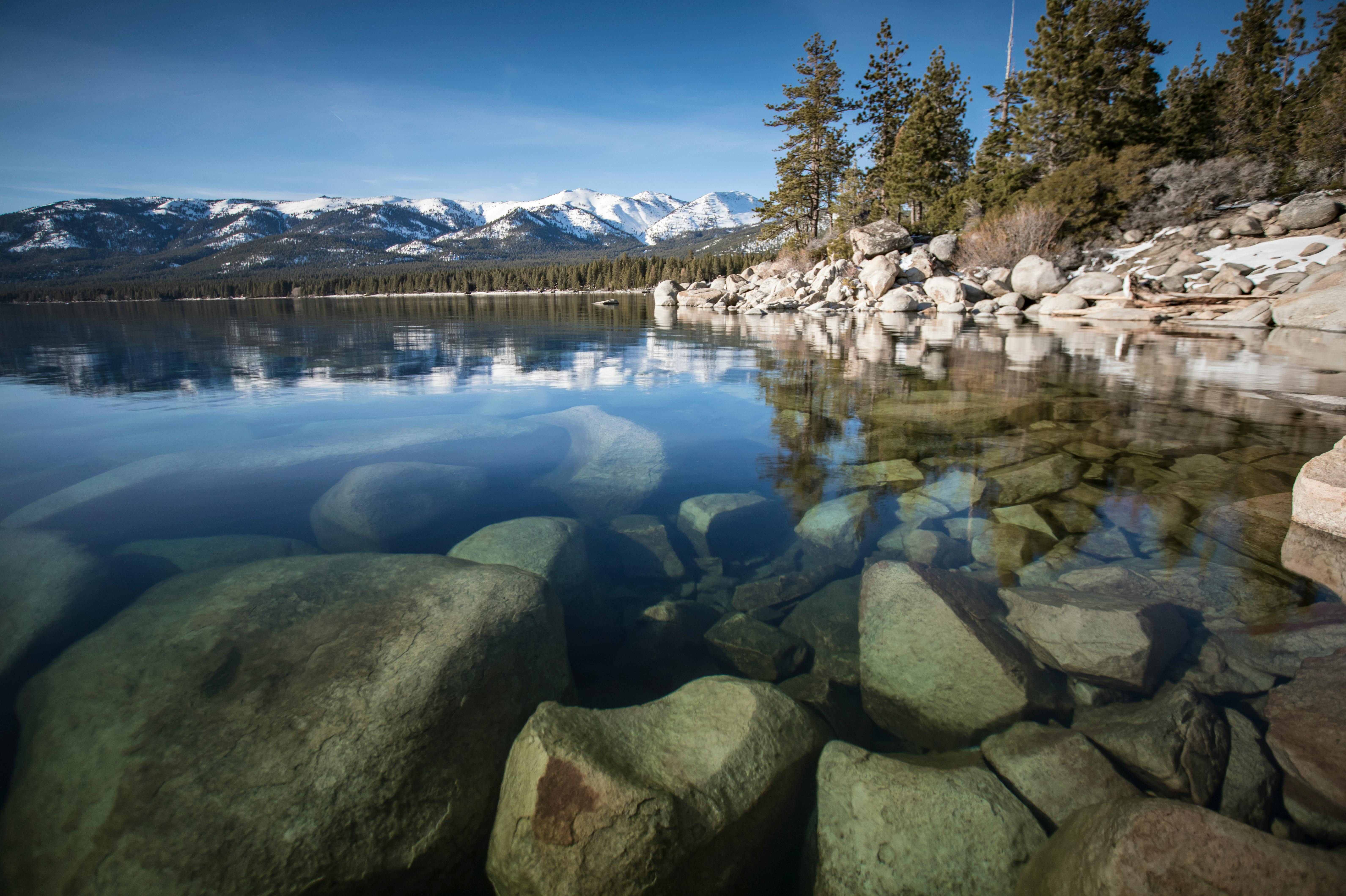 Serene Lake Tahoe with Rocky Shoreline and Mountains by [Stephen Leonardi](https://www.pexels.com/@stephen-leonardi-587681991/) on [Pexels](https://www.pexels.com/photo/aerial-photography-of-concrete-road-1646164/)