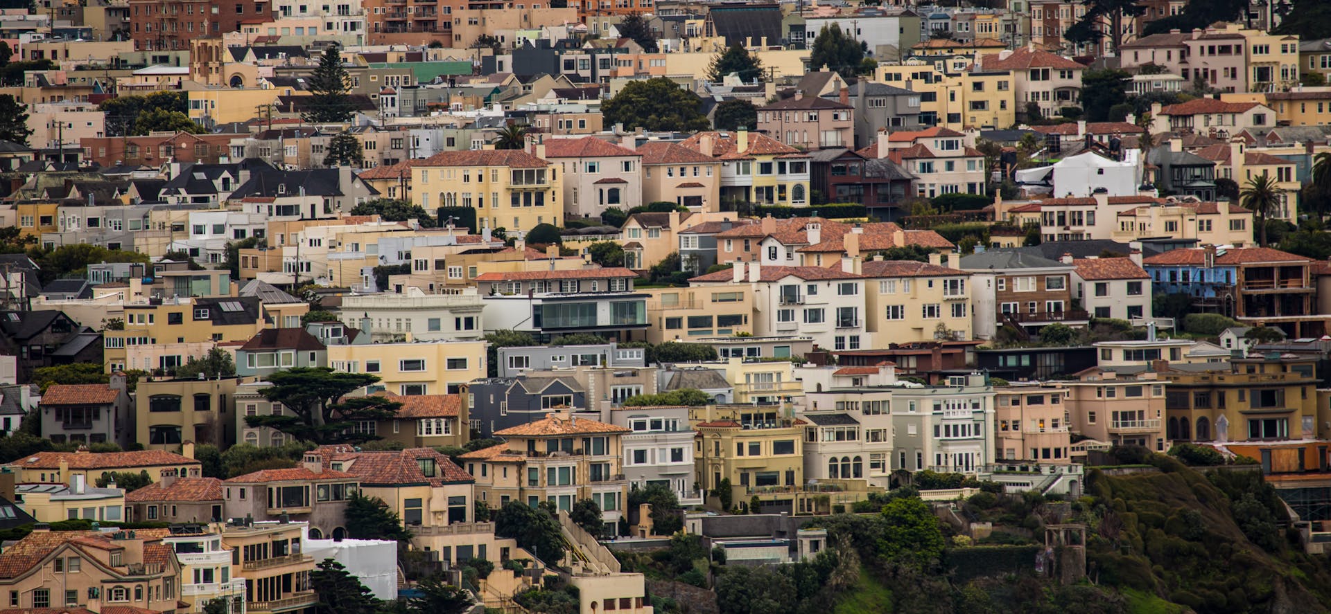 Colorful residential neighborhood in San Francisco with diverse architecture and dense housing.