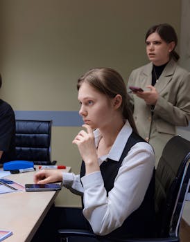 Young professional women in a modern office setting, focused on work.