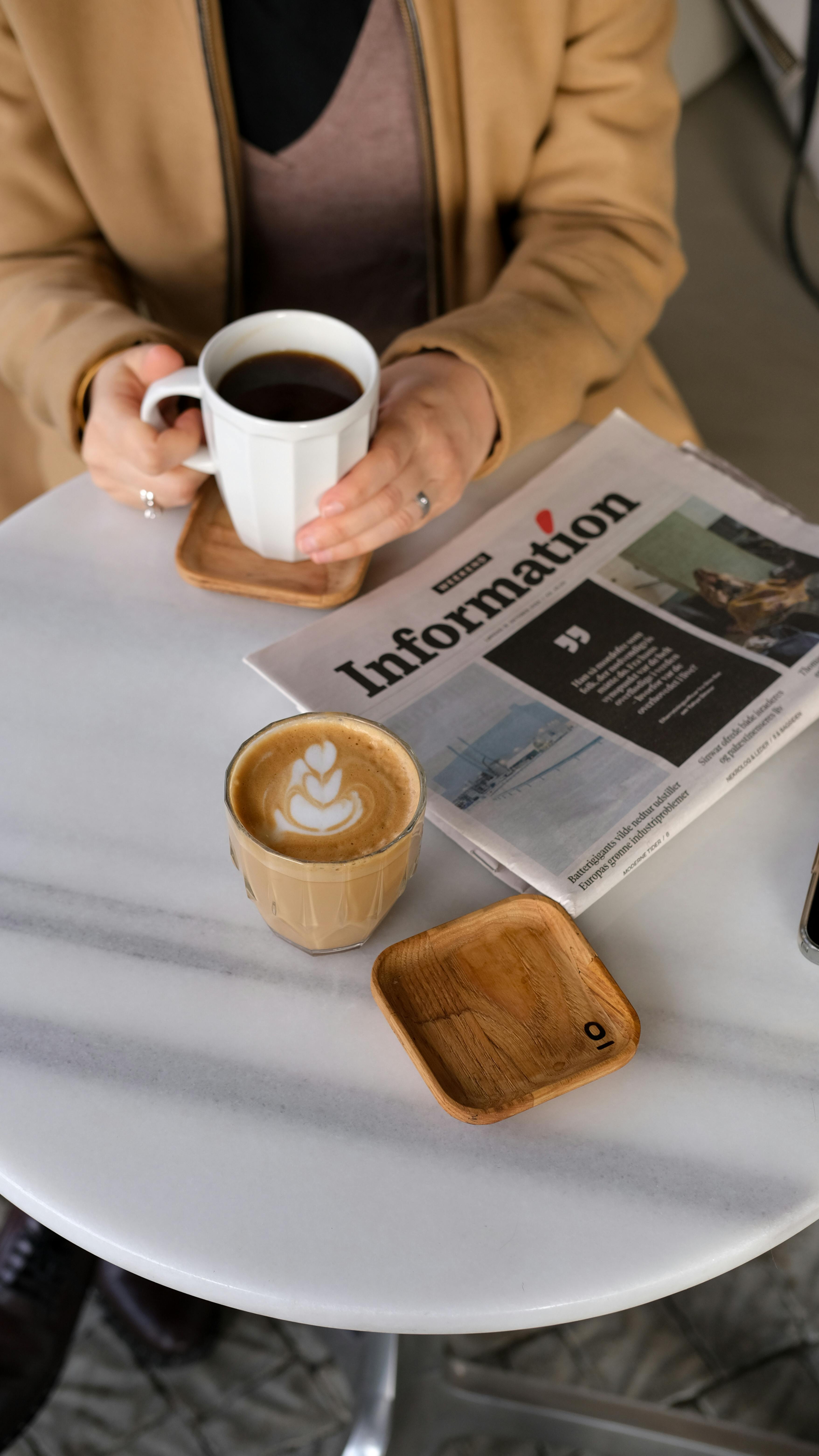 casual coffee break with newspaper in cafe