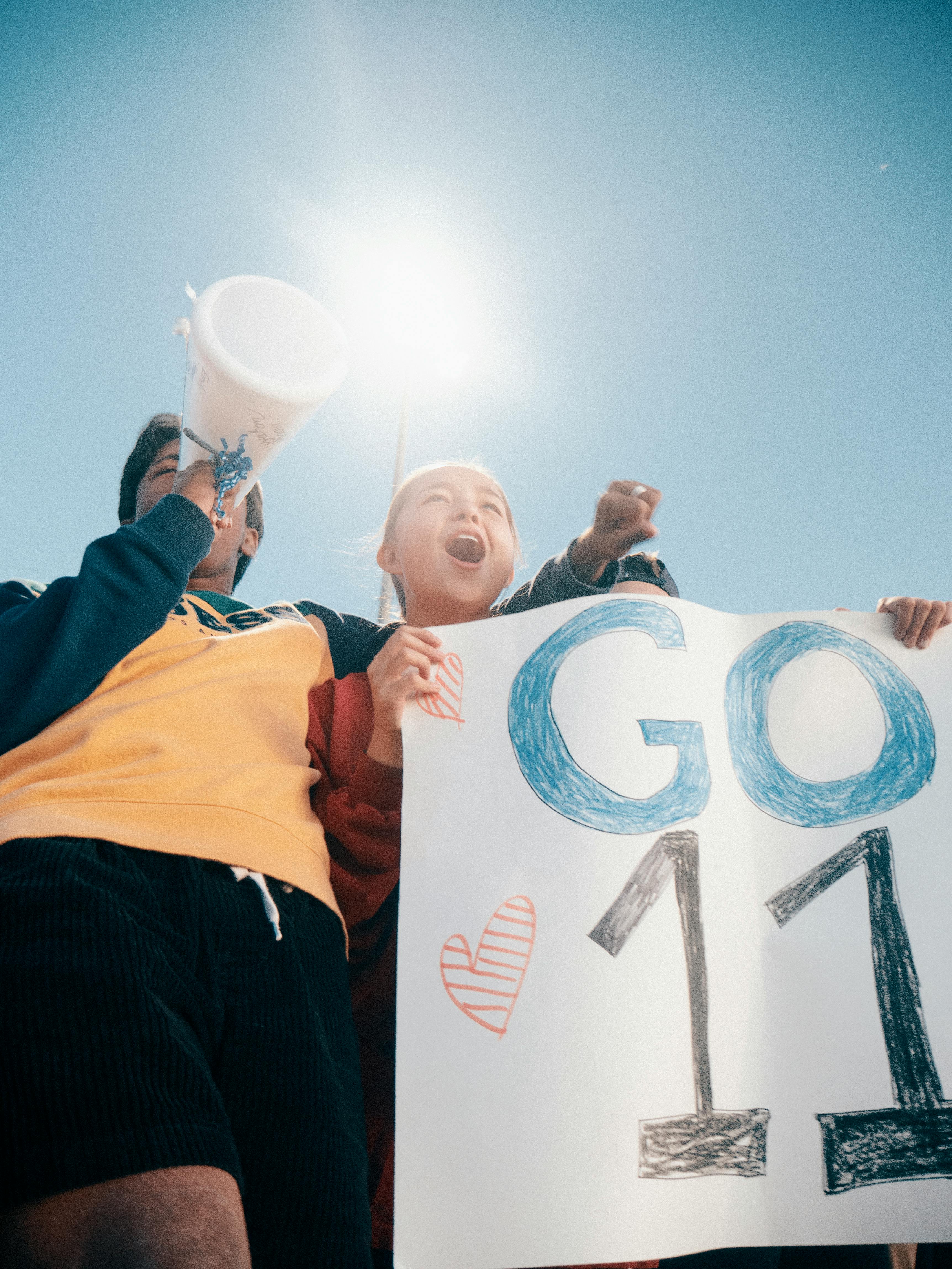 Woman Holding Go 11 Banner