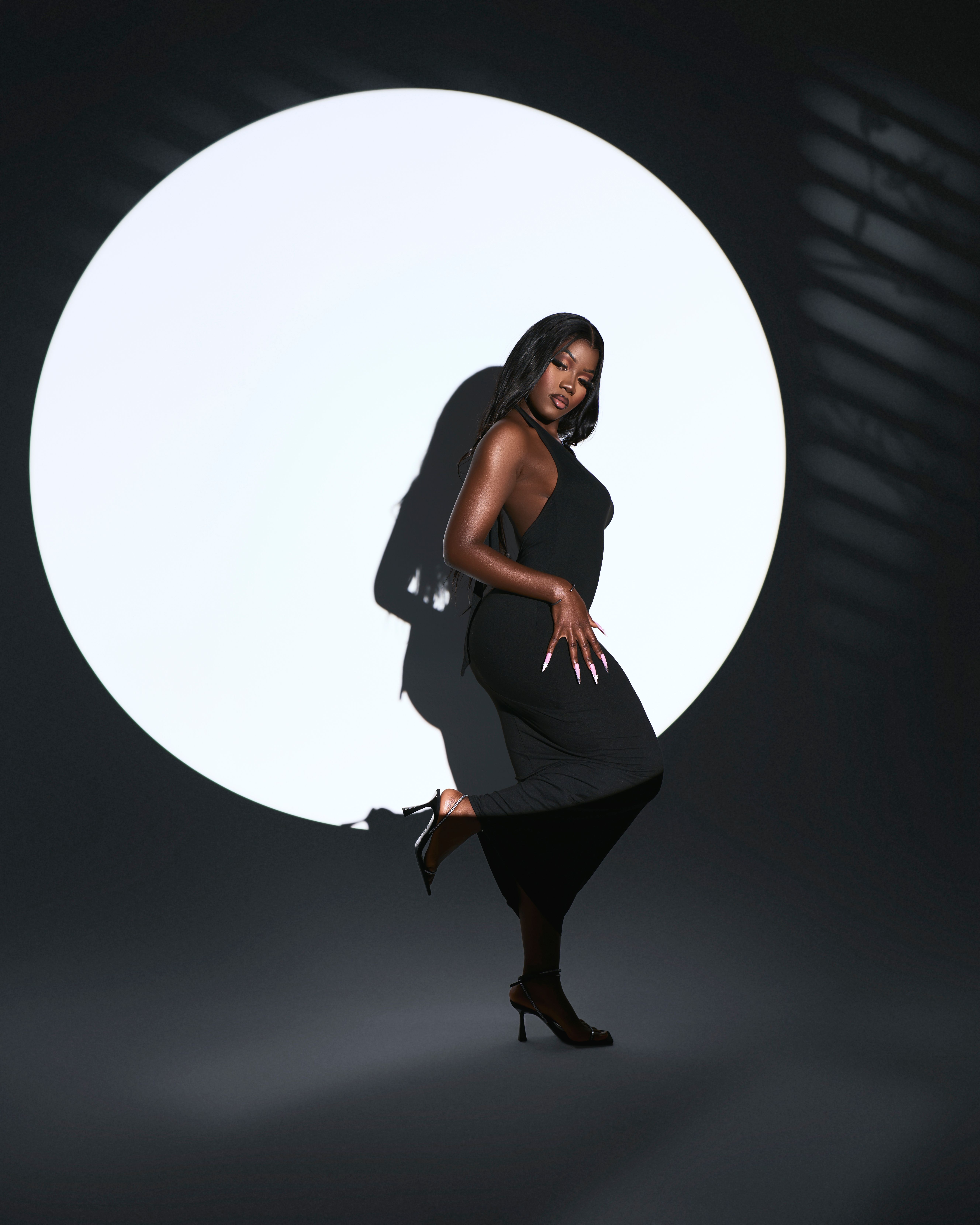 Elegant Woman in Black Dress with Dramatic Shadow · Free Stock Photo