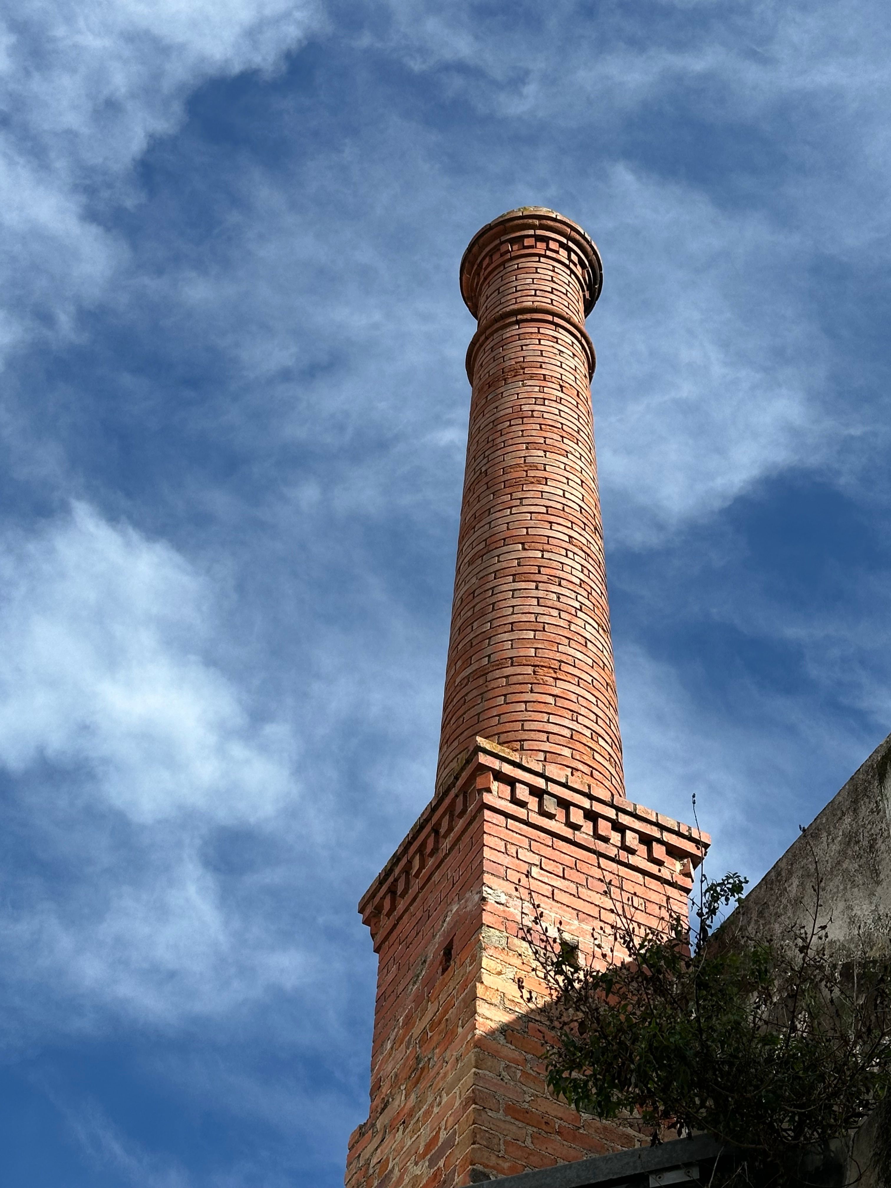 Historic Brick Chimney Against Blue Sky · Free Stock Photo