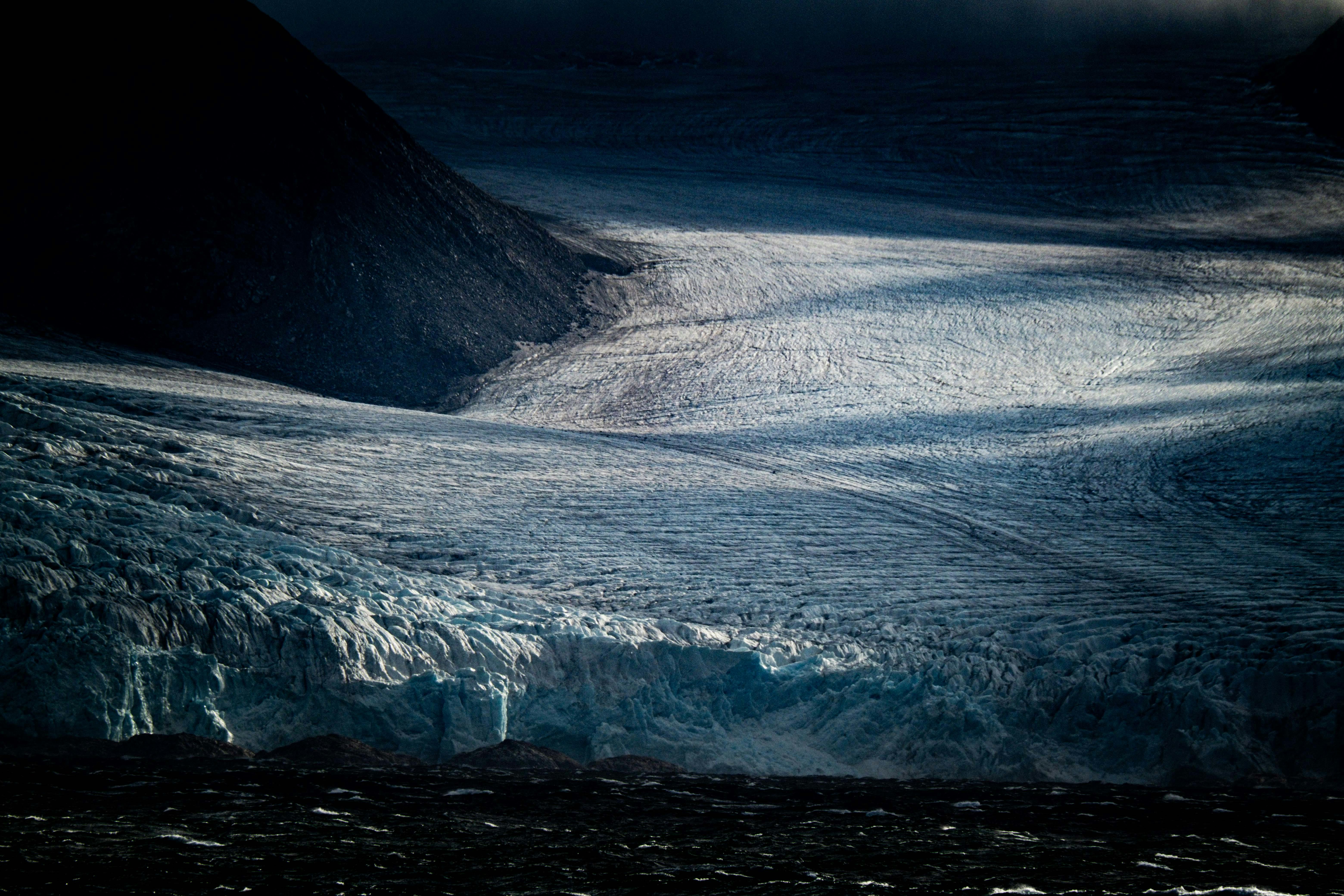 A stunning glacier landscape with moody lighting, captured in twilight.