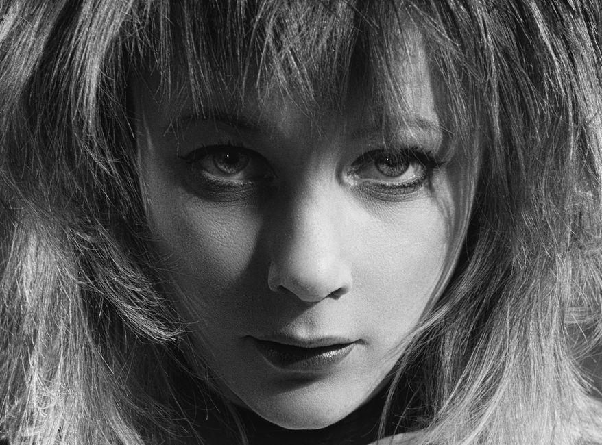 Dramatic black and white portrait of a woman with intense gaze.