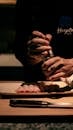 Chef Seasoning Sushi in Dimly Lit Kitchen