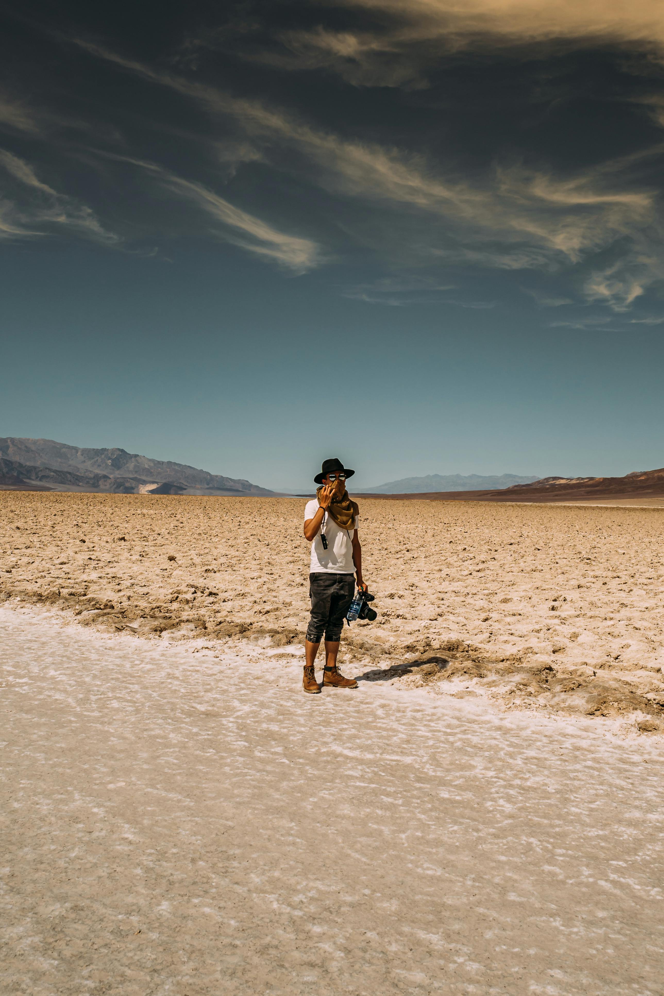 man wearing white crew neck t shirt standing near road