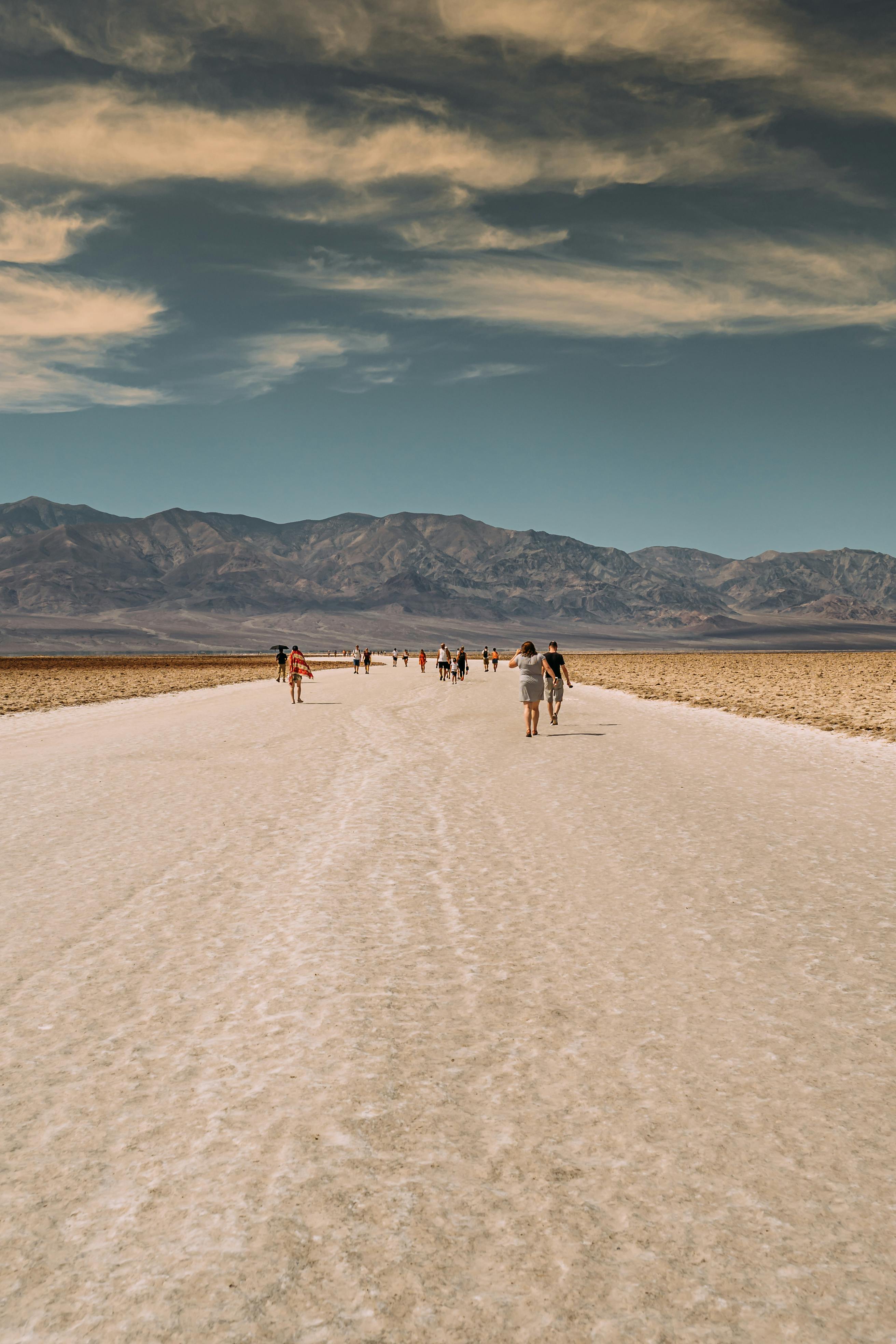 people on road under blue sky