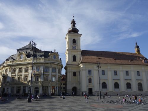 Free View of the historic Great Square in Sibiu, featuring iconic architecture under a clear blue sky. Stock Photo